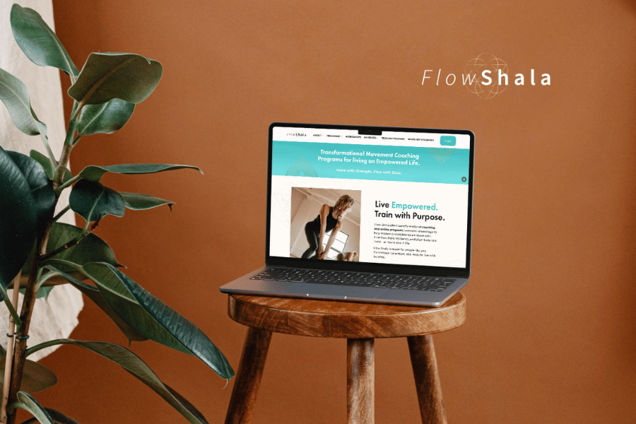 Flowshala website on a laptop sitting on a wooden stool