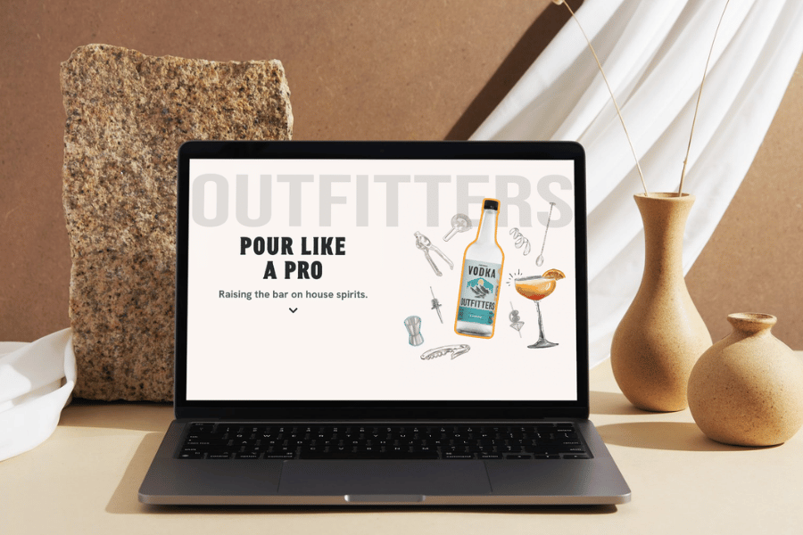 Outfitters website on a laptop in a warm, styled setting