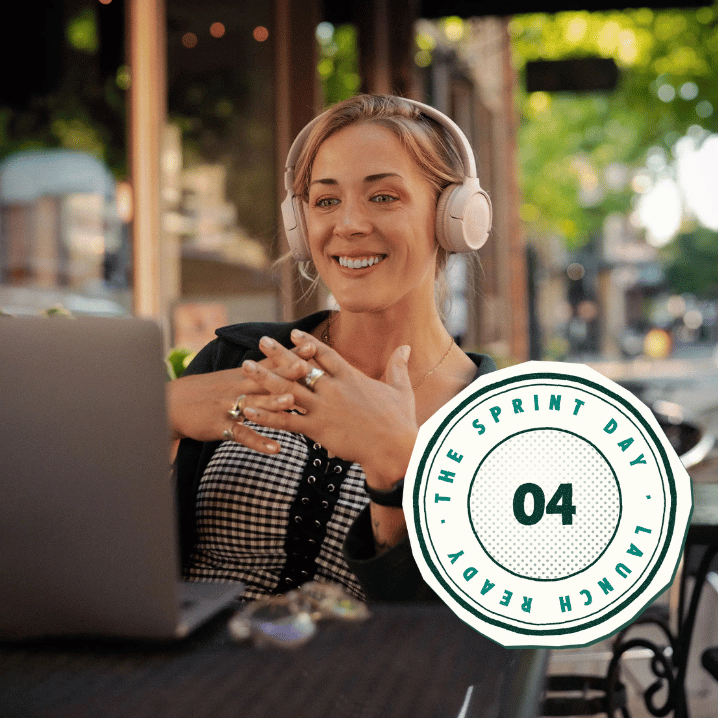Alise Skiba in headphones smiling at her laptop at a café table, with a “04 · The Sprint Day · Launch Ready” stamp